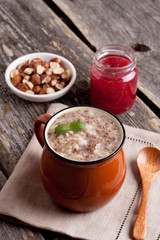 oatmeal with banana, jam and walnuts for breakfast, close-up