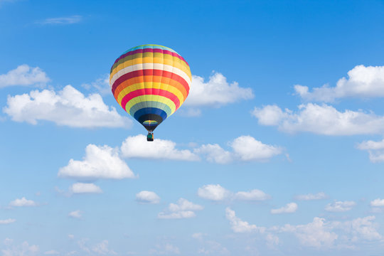 Colorful hot air balloon on blue sky background