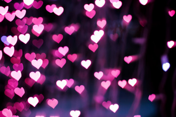 Blurring lights bokeh background of pink hearts