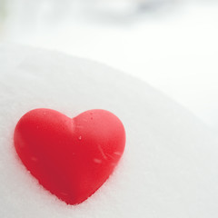 Red heart on the snow