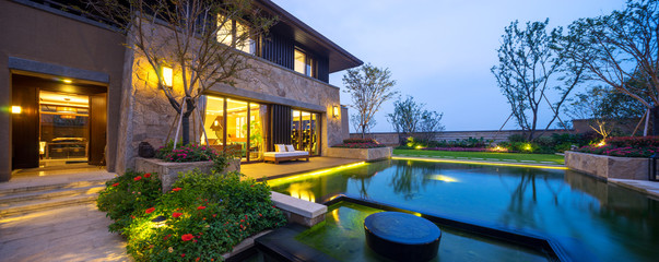 exterior of modern building near pond at twilight