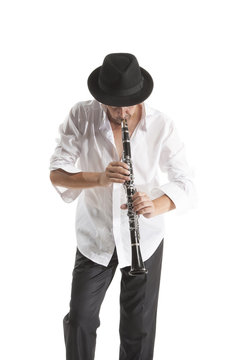 man in hat playing clarinet