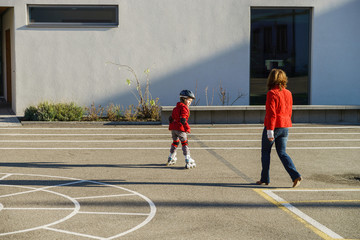 Little girl training to run by rollers