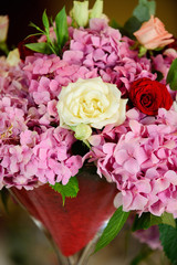 floral arrangement of pink hydrangeas and red roses for event or wedding celebration