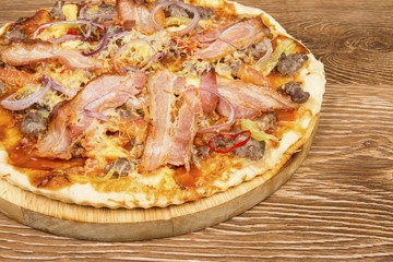 Pizza on dark wooden background. Stock image macro.
