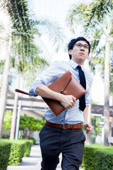 Young Business Asian exhausted man running late for work