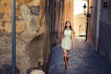 Fototapeta na wymiar Smiling young long-haired Bohemian girl in Prague.