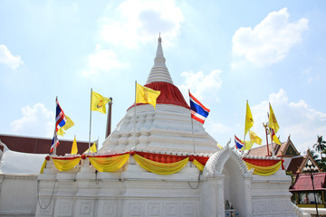 White pagoda against blue sky at Wat Poramaiyikawas Temple in No