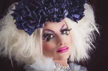Drag queen with spectacular makeup, glamorous trashy look, posing happily and charming camera from...