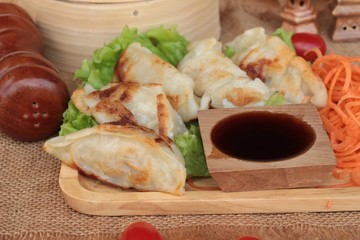 Fried gyoza and sauces - traditional Japanese food.