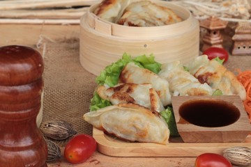 Fried gyoza and sauces - traditional Japanese food.