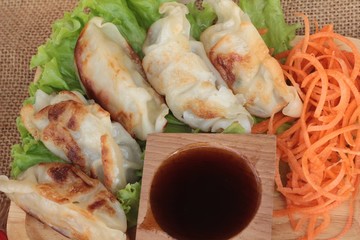 Fried gyoza and sauces - traditional Japanese food.