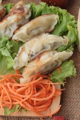 Fried gyoza and sauces - traditional Japanese food.
