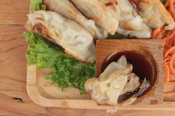Fried gyoza and sauces - traditional Japanese food.
