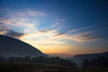 Mysterious fog in the tent camp at sunrise time