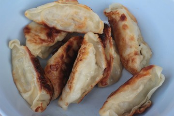 Fried gyoza and sauces - traditional Japanese food.