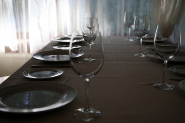 table setting in restaurant Cutlery near the window, backlit