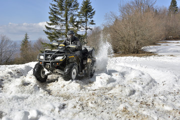 man driving a quad bike in the winter field © brszattila