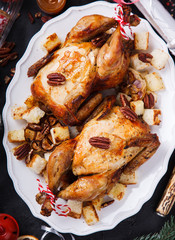  Baked chicken with oranges,champagne,pecans, garlic and rosemary.Dinner for Christmas and New year.Thanksgiving Dinner. selective focus.