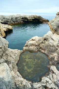 Natural pool filled with sea water .