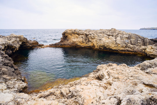 Natural pool filled with sea water .