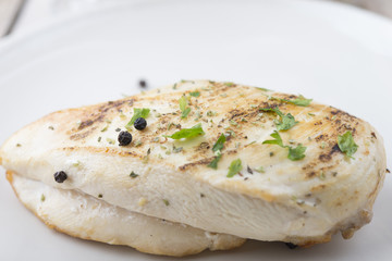 Grilled chicken breast with fresh vegetables .