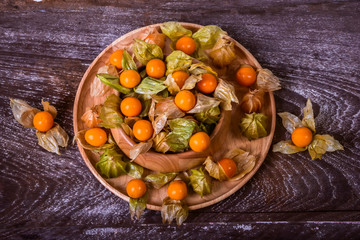 Cape Gooseberry on a wooden bowl