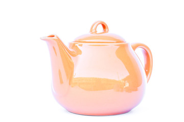 Orange ceramic teapot isolated on white background