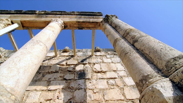 Slow-moving tracking footage of roofless columns