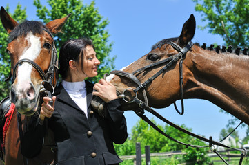 young horsewoman with two horse