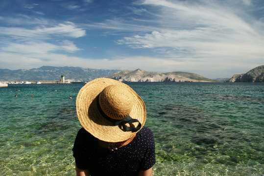 Woman standing by the sea, Krk, Stara Baska, Croatia