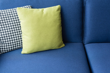green pillow on blue sofa