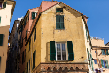 Fototapeta na wymiar Genoa, ancient sea port city, streets and houses in a sunny day
