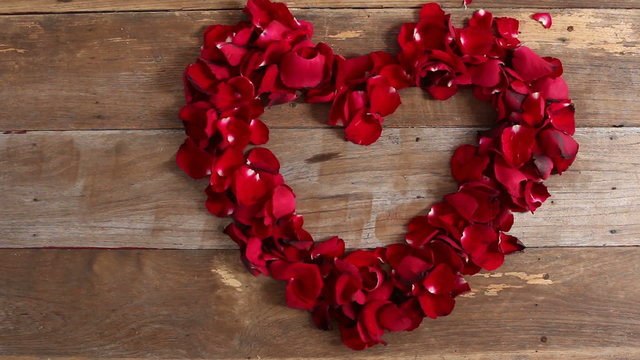 HD Dolly,Valentines Day Heart Made of Red Roses petals on old wood background 