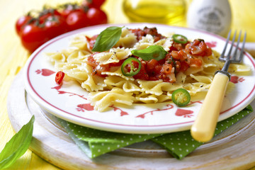 Pasta farfalle with tomato sauce.