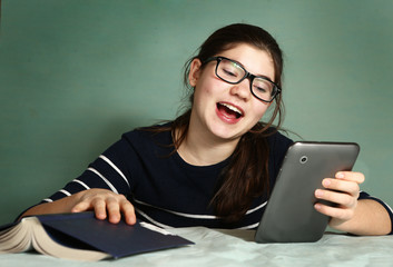 teenager girl in myopia glasses play online game