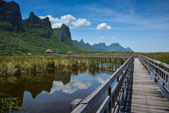 Wooden bridge with mountain and lake landscape