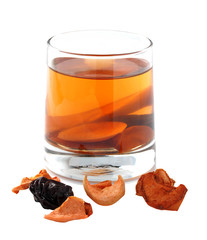 Assorted dried fruit compote in a glass on a white background. I