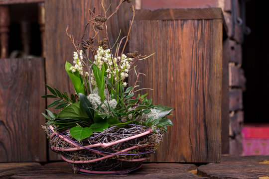 Lily on the valley in handmade basket  decor composition