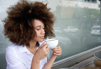 Young woman enjoying cup of coffee