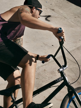 Young boy doing jumps on his BMX bike in a skate park.
