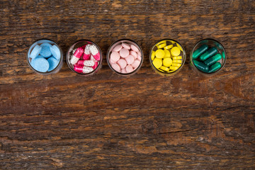 Various pills and capsules in glass containers