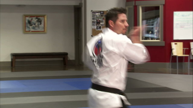 Close up of a man performing Tae Kwon Do.