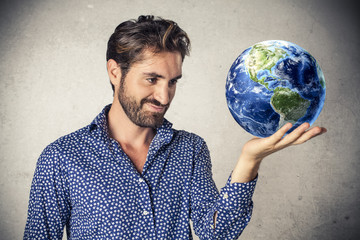 Businessman holding the earth in his hand
