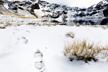 Footprint trace trail steps frozen lake, Condoriri snow mountain