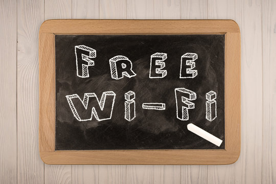 "Free Wi-Fi" chalkboard with  outlined text - on wood