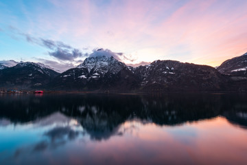 Mountains Alps. Mountain landscape at night. Sky is colored by the setting sun is reflected in the surface of the water.