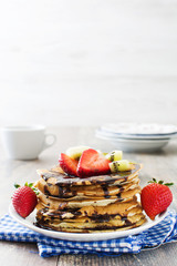 Pancakes with chocolate, strawberries and kiwi

