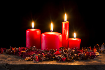 Red candle on wooden plank