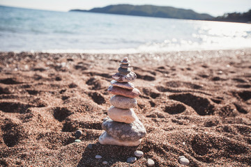 Fototapeta na wymiar stones stacked on each other on the beach